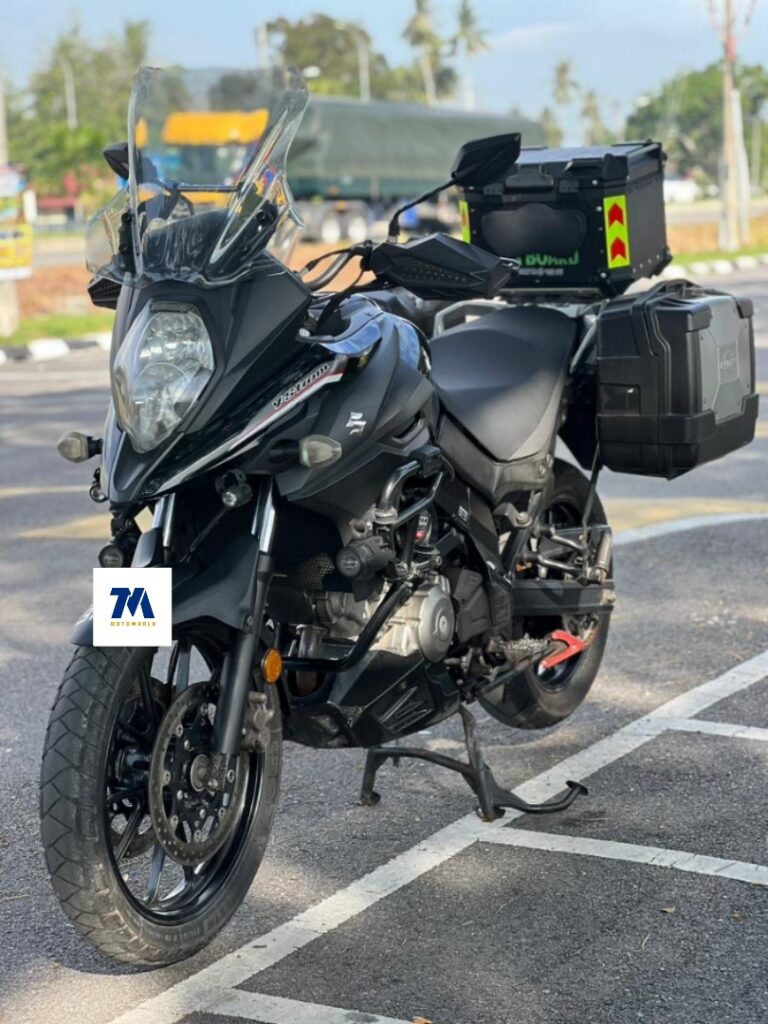 Front view of a black motorcycle with side boxes.