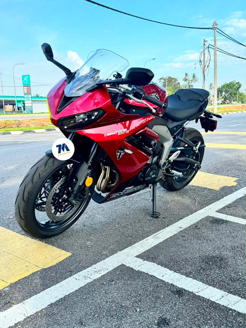 Front view of a red motorcycle with headlight, handlebars, and fairing visible