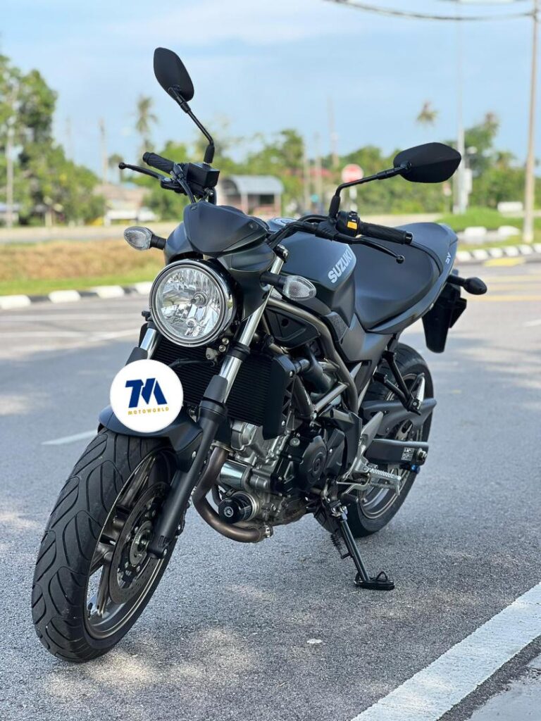 Front view of a black Suzuki motorcycle on the road