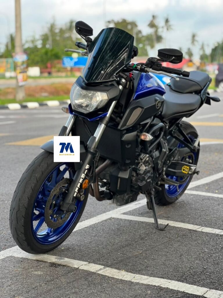 Front view of the blue motorcycle with visible headlight and handlebars.