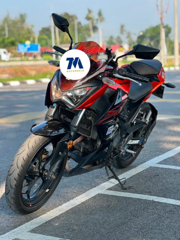 Front view of a red Kawasaki motorcycle with headlight and handlebars visible.