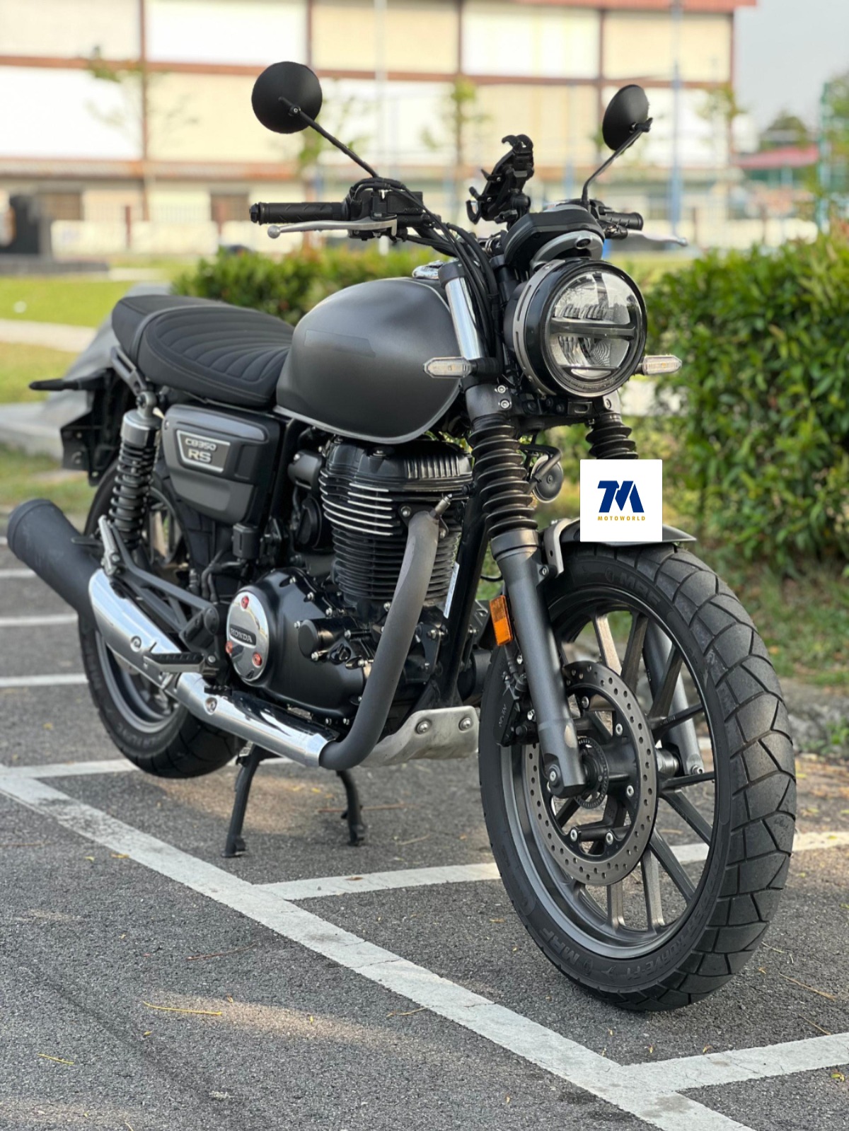 front 3/4 view of a motorcycle with the headlight and handlebars visible