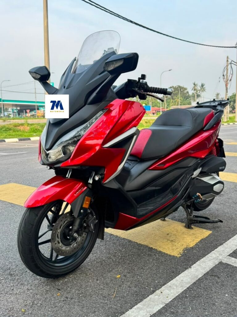 Honda NSS 250 motorcycle in red facing the camera
