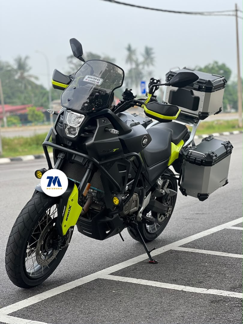front view of black and yellow motorcycle with panniers