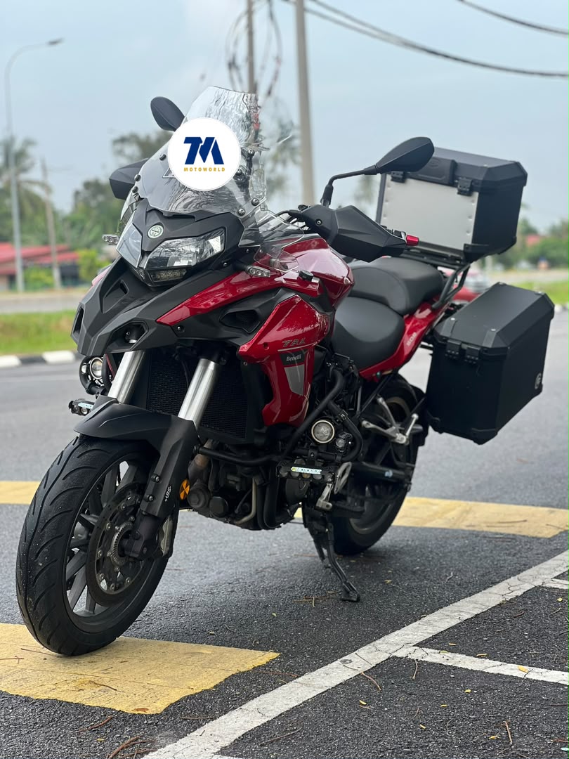 front-facing view of red Benelli motorcycle with panniers