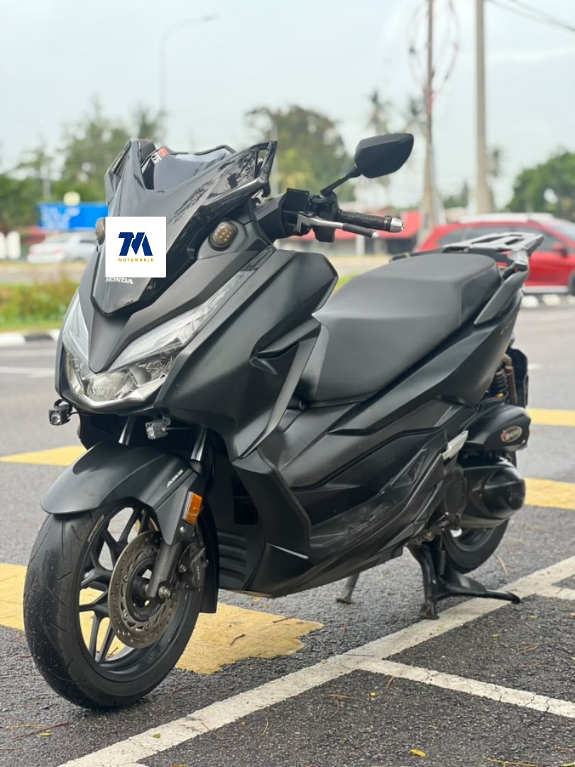 Front view of a black motorcycle with visible headlights and handlebars