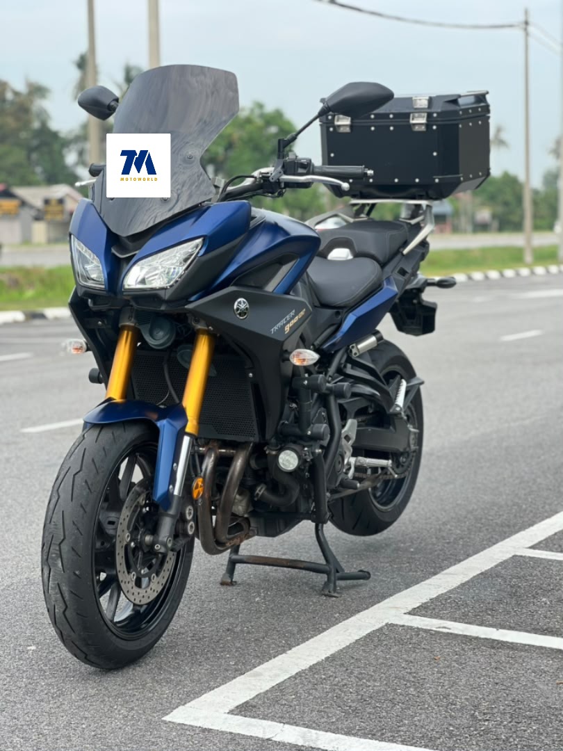 front view of blue motorcycle with black panniers