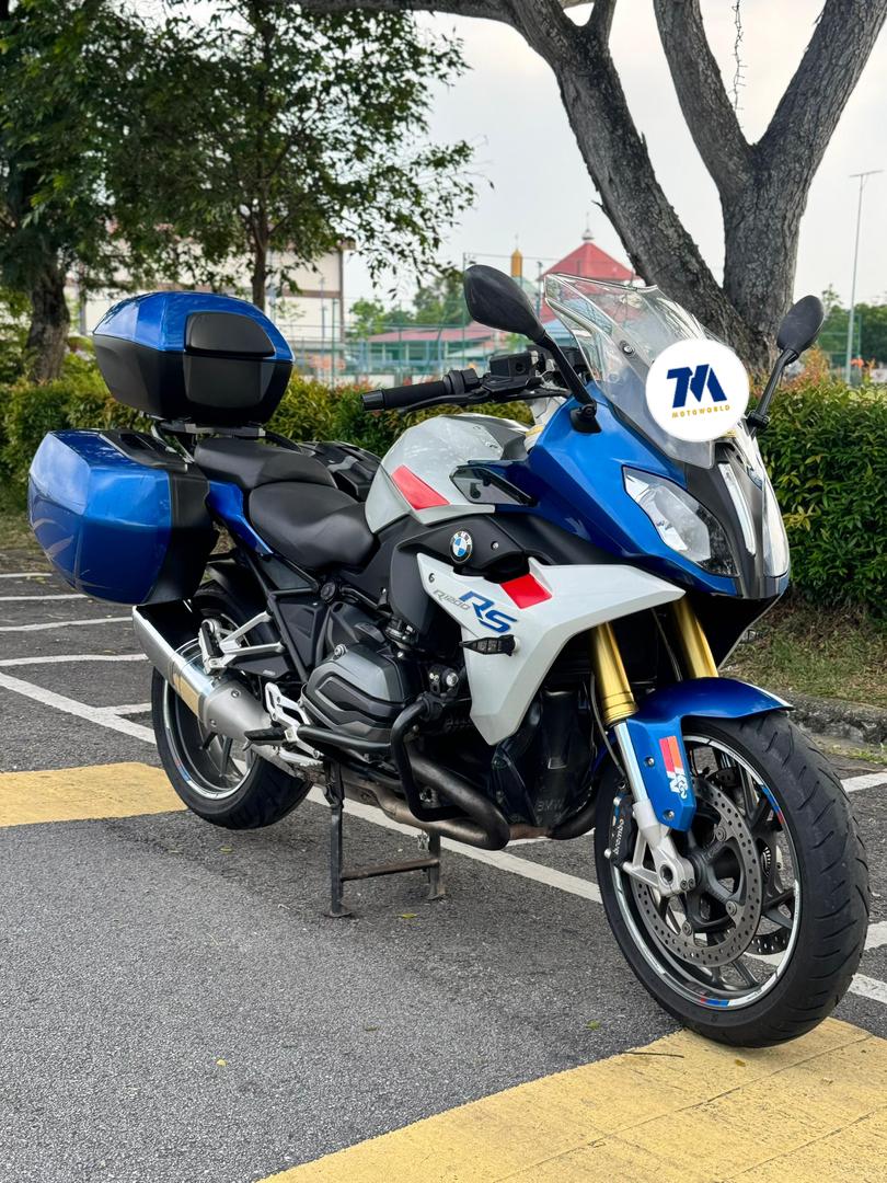 BMW motorcycle facing front-left with blue panniers
