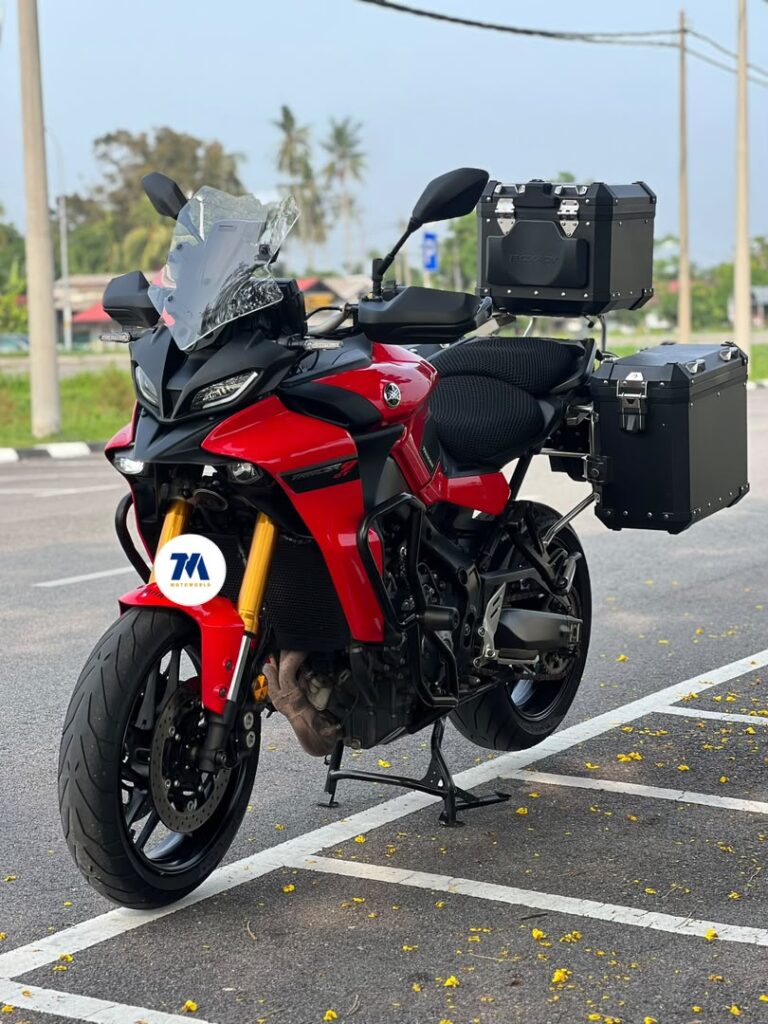 front view of a red Yamaha Tracer 9 GT motorcycle with panniers
