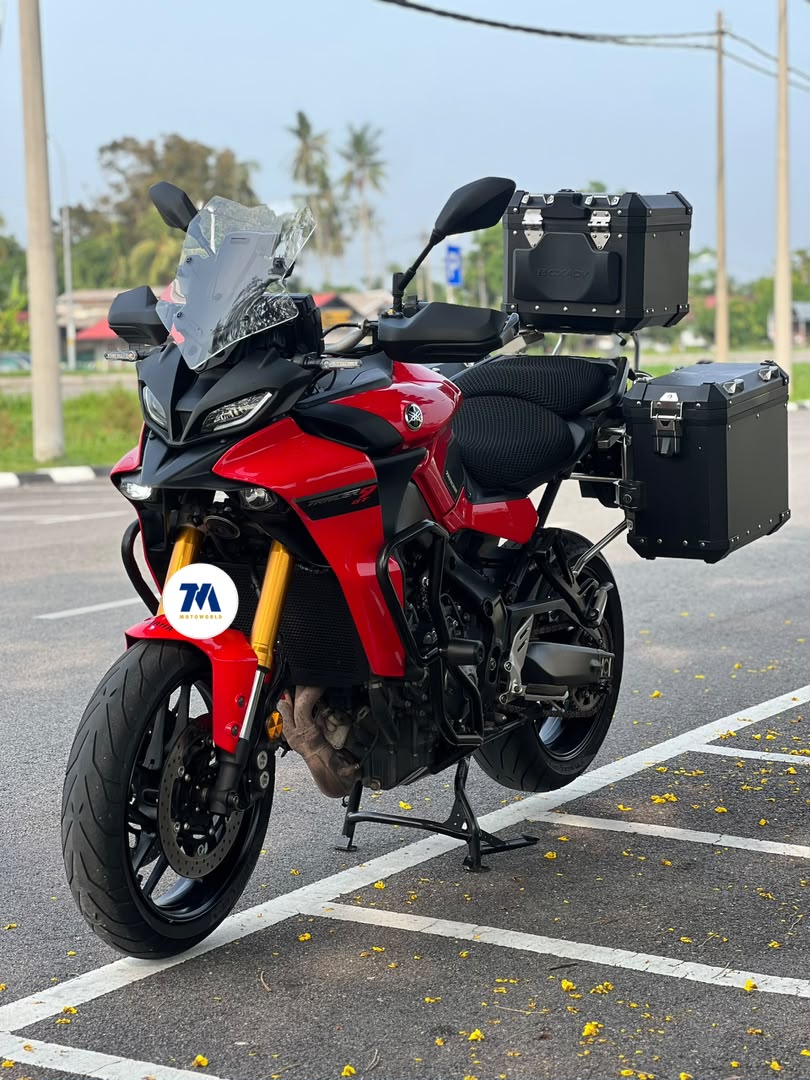 front view of a red Yamaha Tracer 9 GT motorcycle with panniers