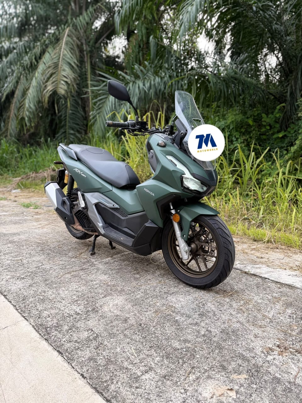 Front 3/4 view of a green Honda ADV160 motorcycle