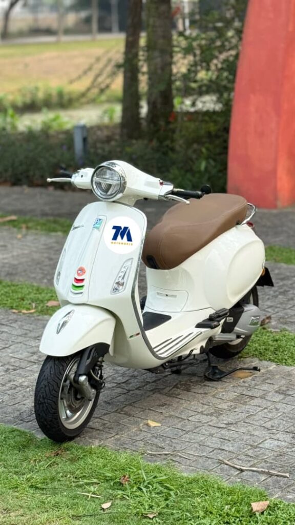 front view of white Vespa with brown seat