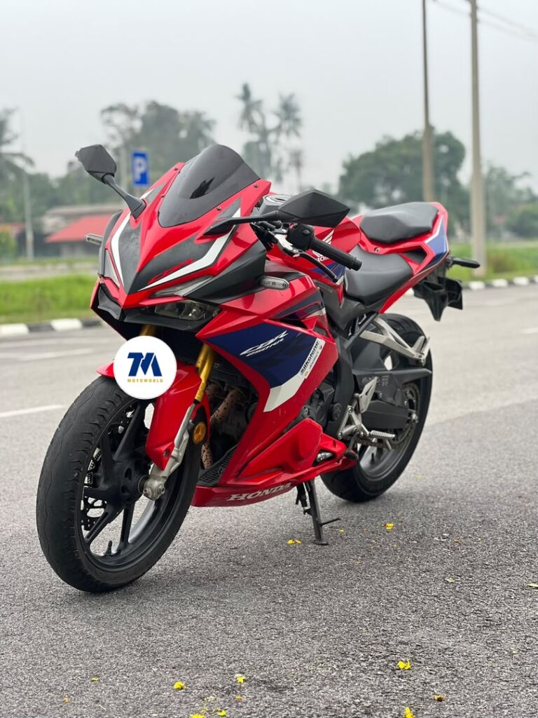 Honda CBR250 facing front with red and blue fairing
