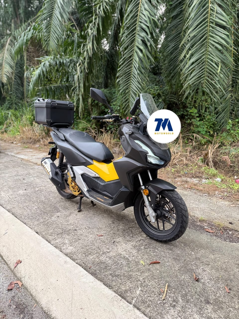front view of a black and yellow Honda ADV160 motorcycle